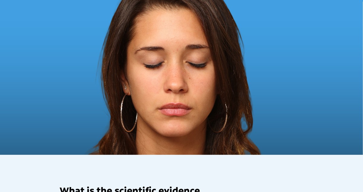A woman meditating with eyes closed